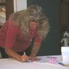 Linda, daughter of Jean, signing the tablecloth